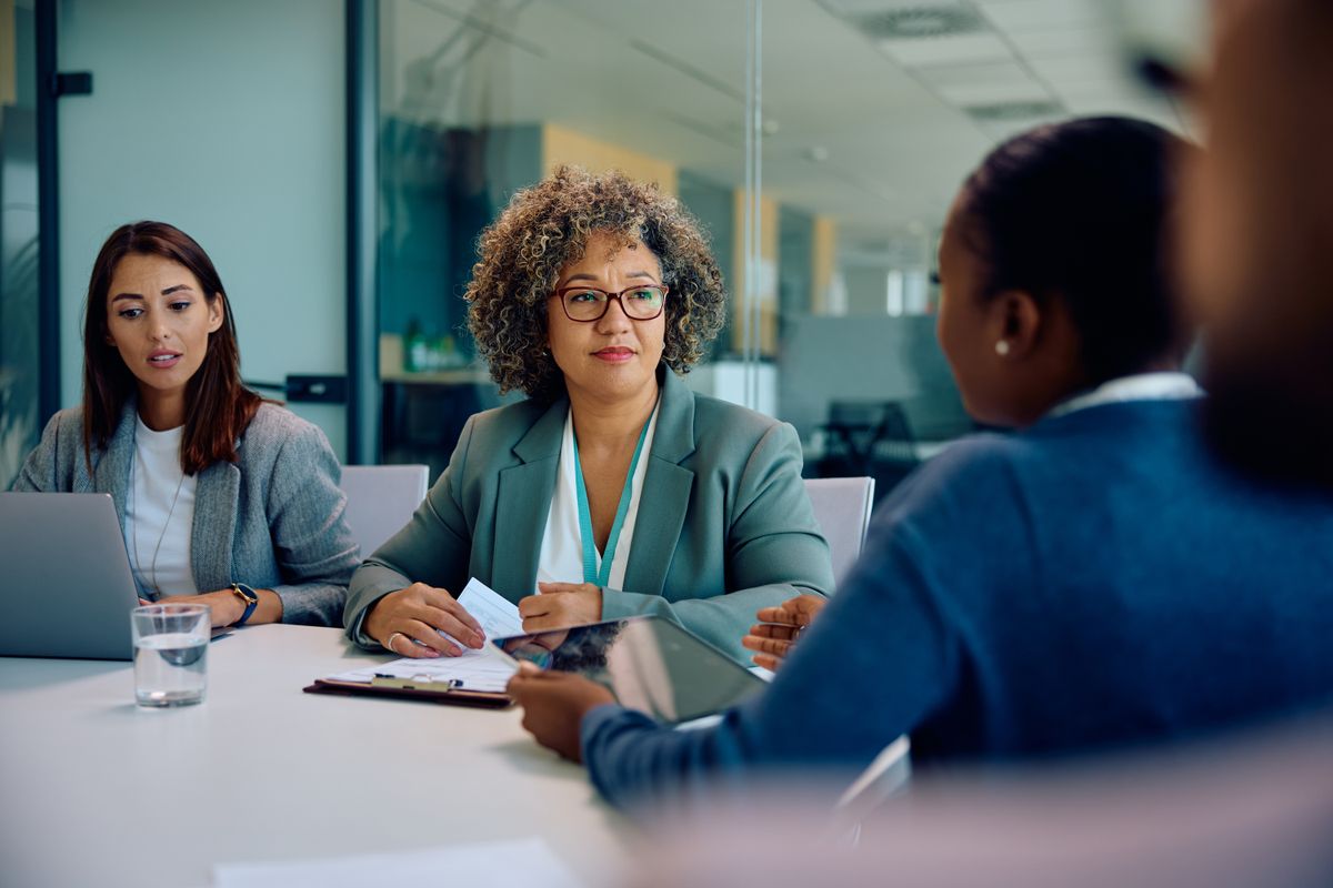 Financial advisor leading a team meeting