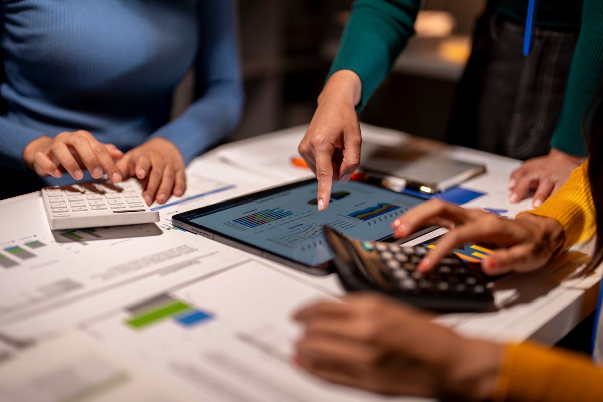 Team reviewing financial data on a tablet