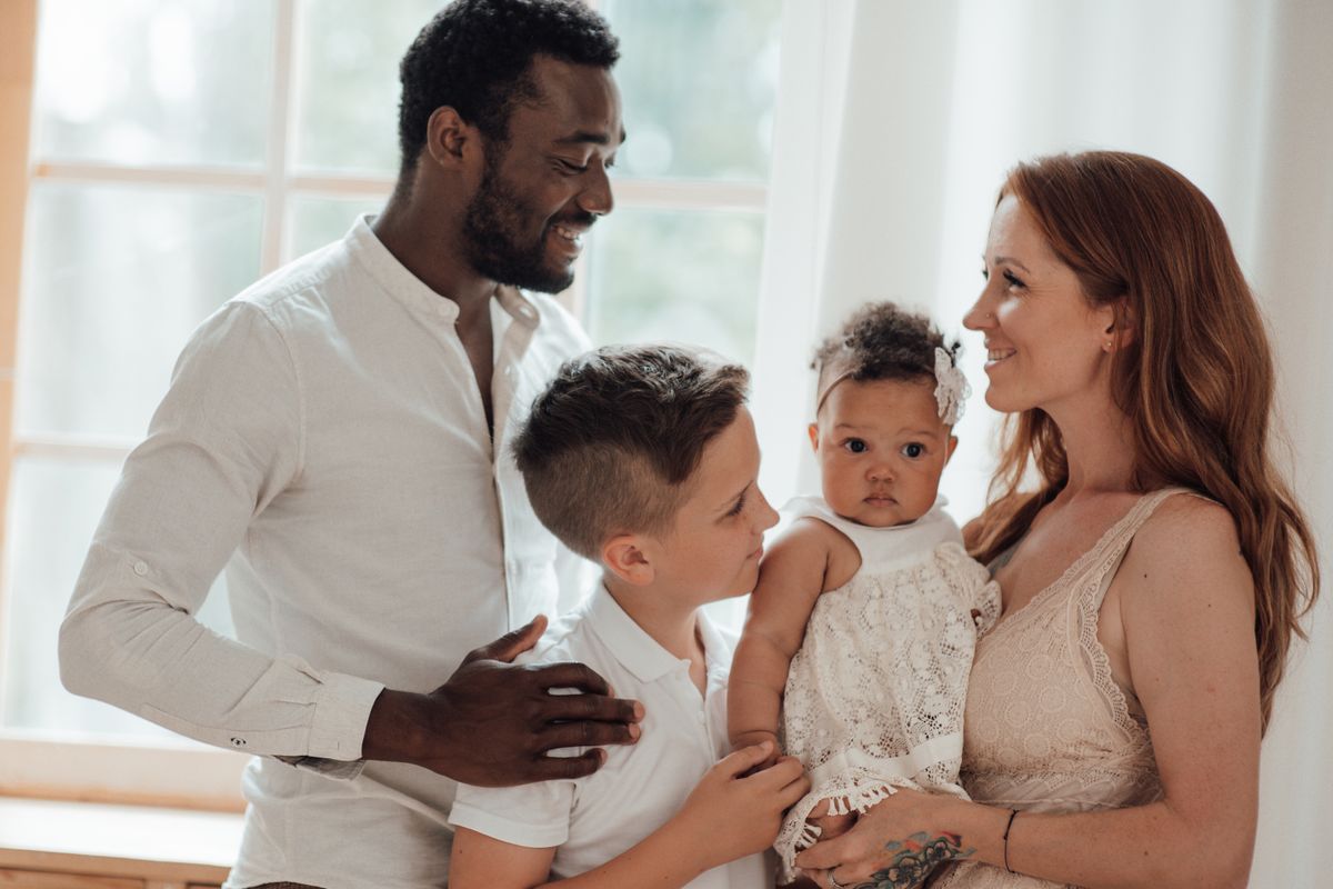Happy family with children by a sunlit window